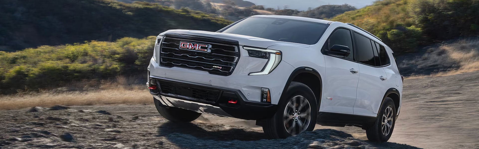 GMC Acadia driving off-road on rugged terrain