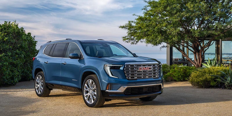 GMC Acadia parked by modern home